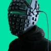 Black plastic helmet made of green LED lights, keyboard keys, scrap computer parts, and laptop charger.