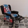 Thrifted recliner reupholstered with Dance Dance Revolution dance mats, and stretch Pleather fabric.
