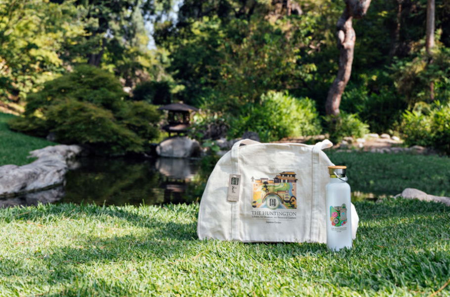 Huntington Library tote bag sitting in a garden